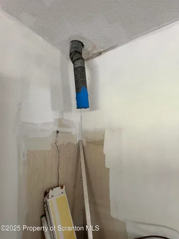 a view of a grassy field with trees in the background