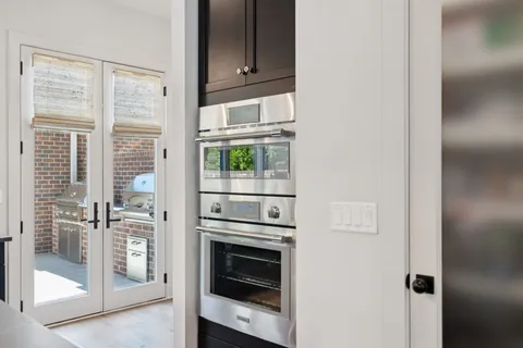 a view of a hallway with wooden floor and closet