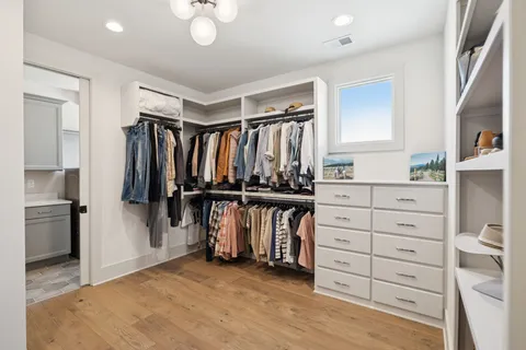 a view of kitchen and closet with wooden floor