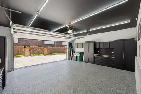 a view of a hallway with wooden floor and windows