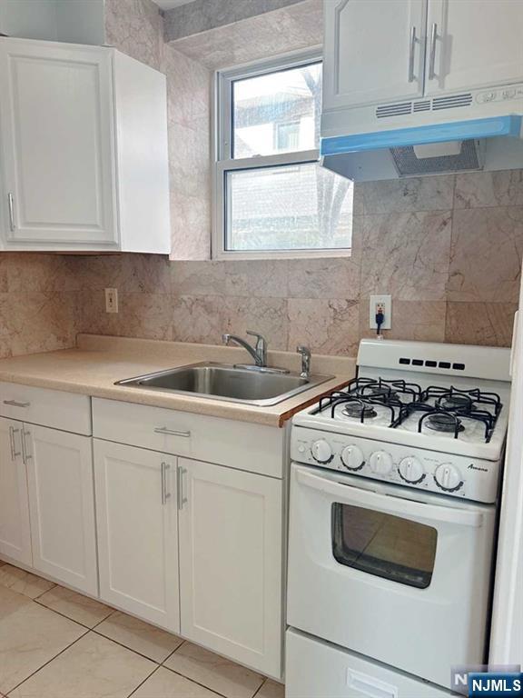 2443 3rd Street, Unit 1 Fort Lee, NJ 07024 - Photo 6 of 8 a white stove top oven sitting inside of a kitchen