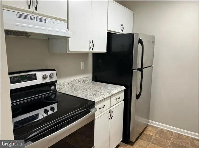a kitchen with appliances and cabinets