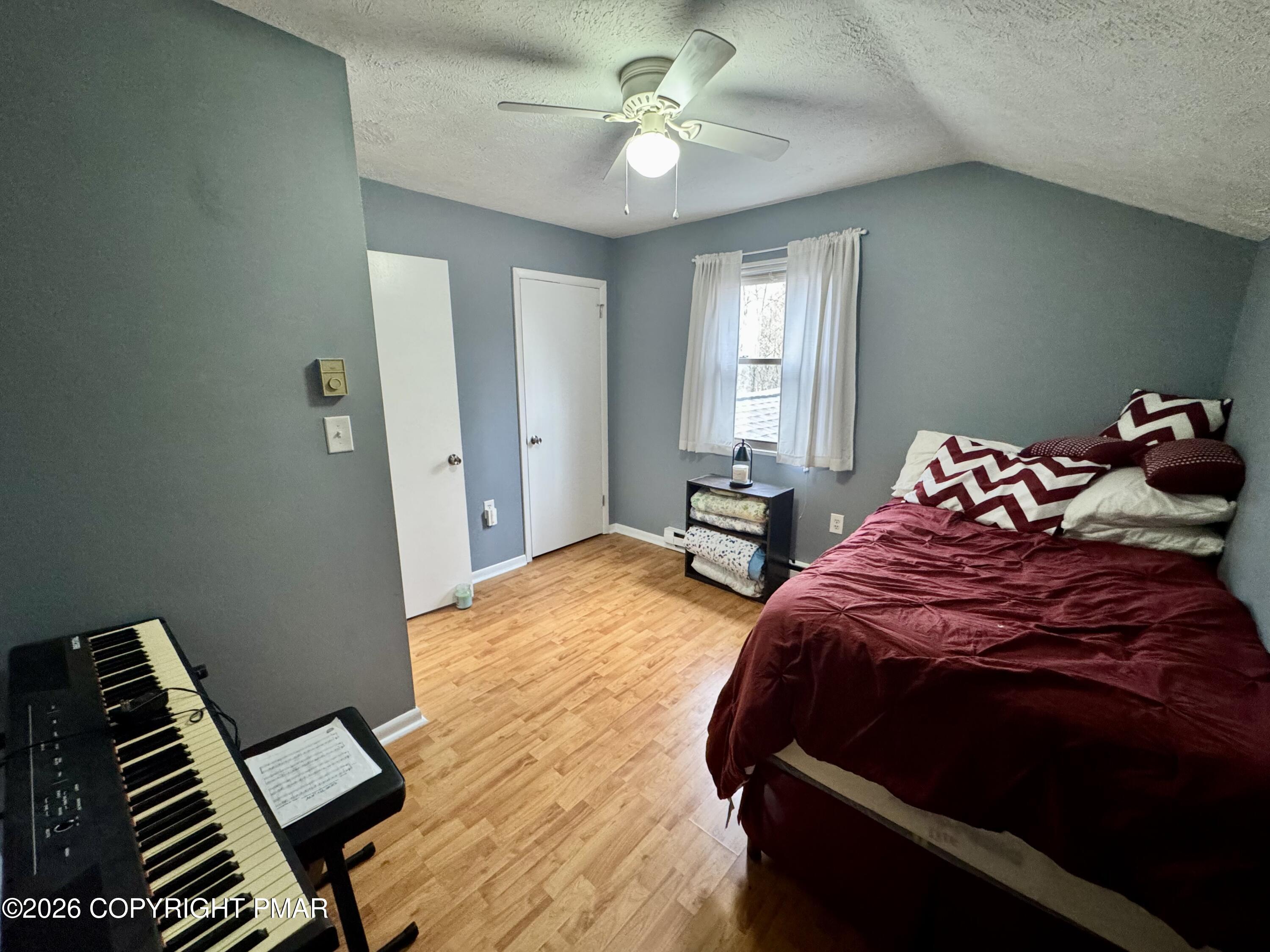 1169 Coolbaugh Road East Stroudsburg, PA 18302 - Photo 15 of 26 a bedroom with a bed and a chandelier