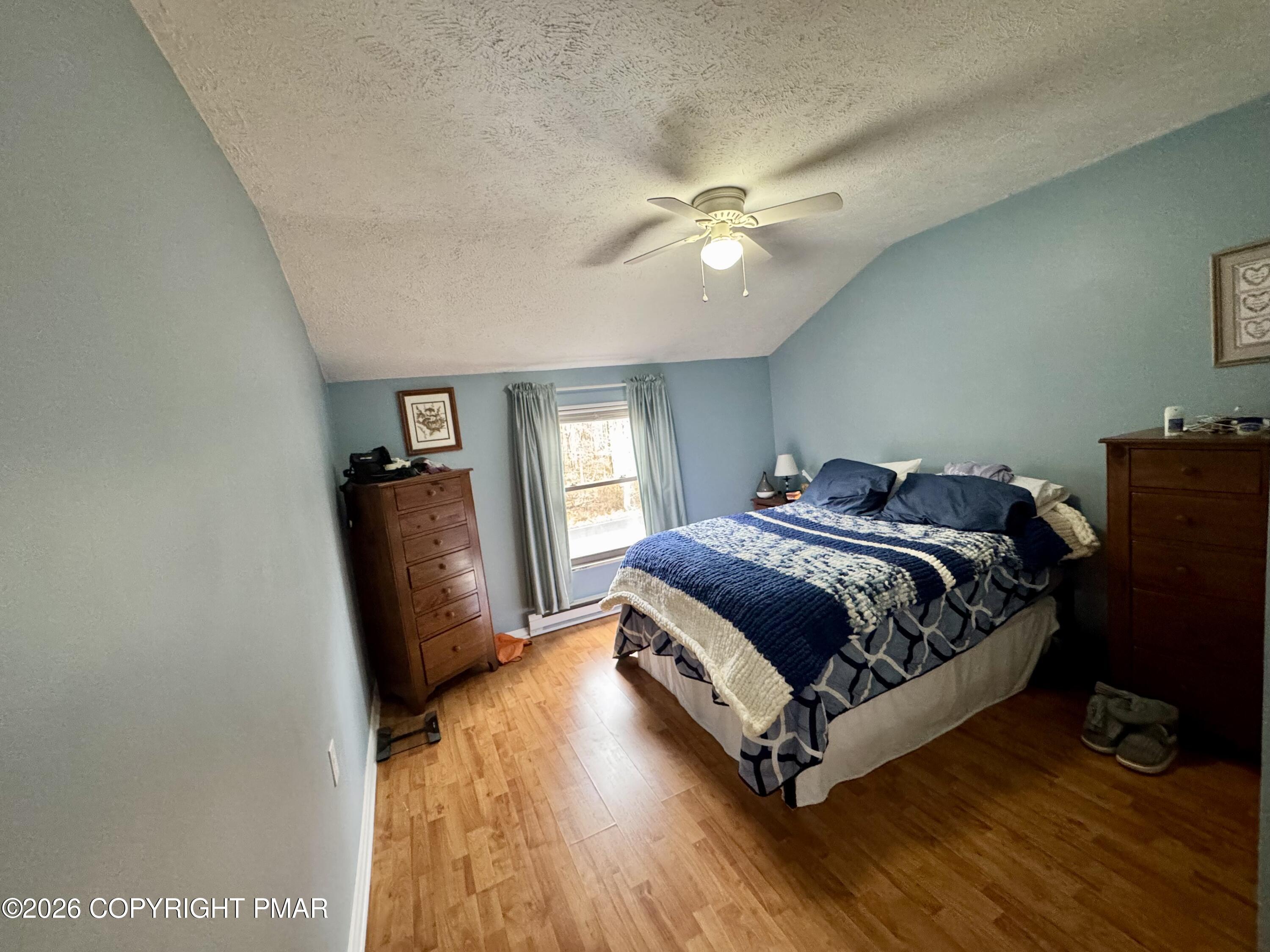 1169 Coolbaugh Road East Stroudsburg, PA 18302 - Photo 17 of 26 a bedroom with a bed lamp on desk and a window