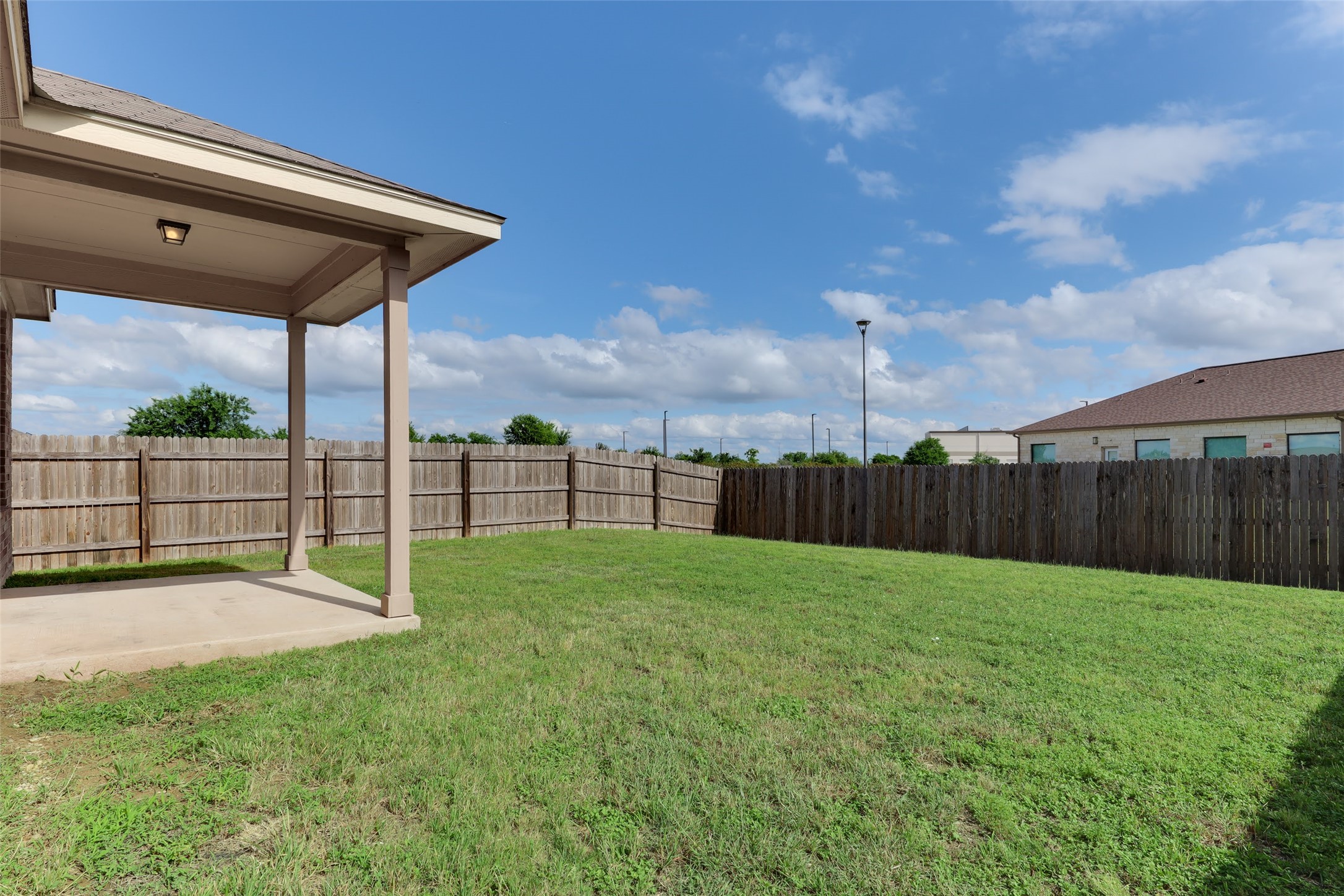 18705 Moreto Loop Pflugerville, TX 78660 - Photo 20 of 21 A spacious backyard with a private wooden fence, perfect for outdoor enjoyment.