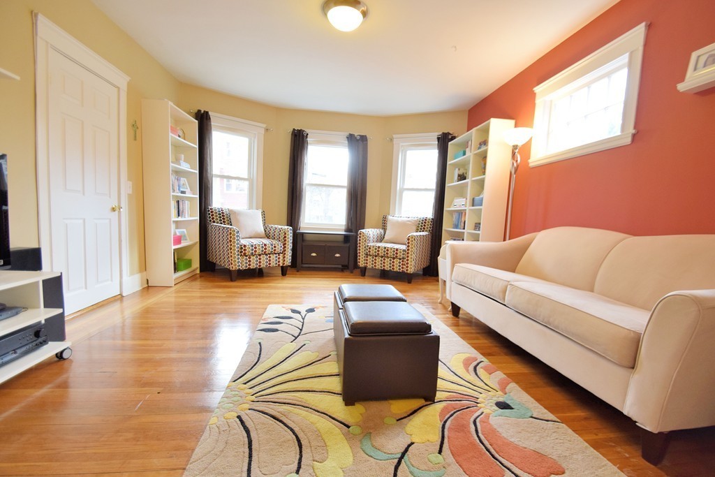 91-93 Rossmore Road, Unit 1 Boston, MA 02130 - Photo 3 of 16 a living room with furniture and a large window