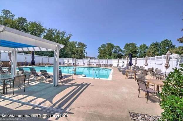211 Potts Road Morganville, NJ 07751 - Photo 29 of 29 a view of a patio with dining table and chairs with a patio