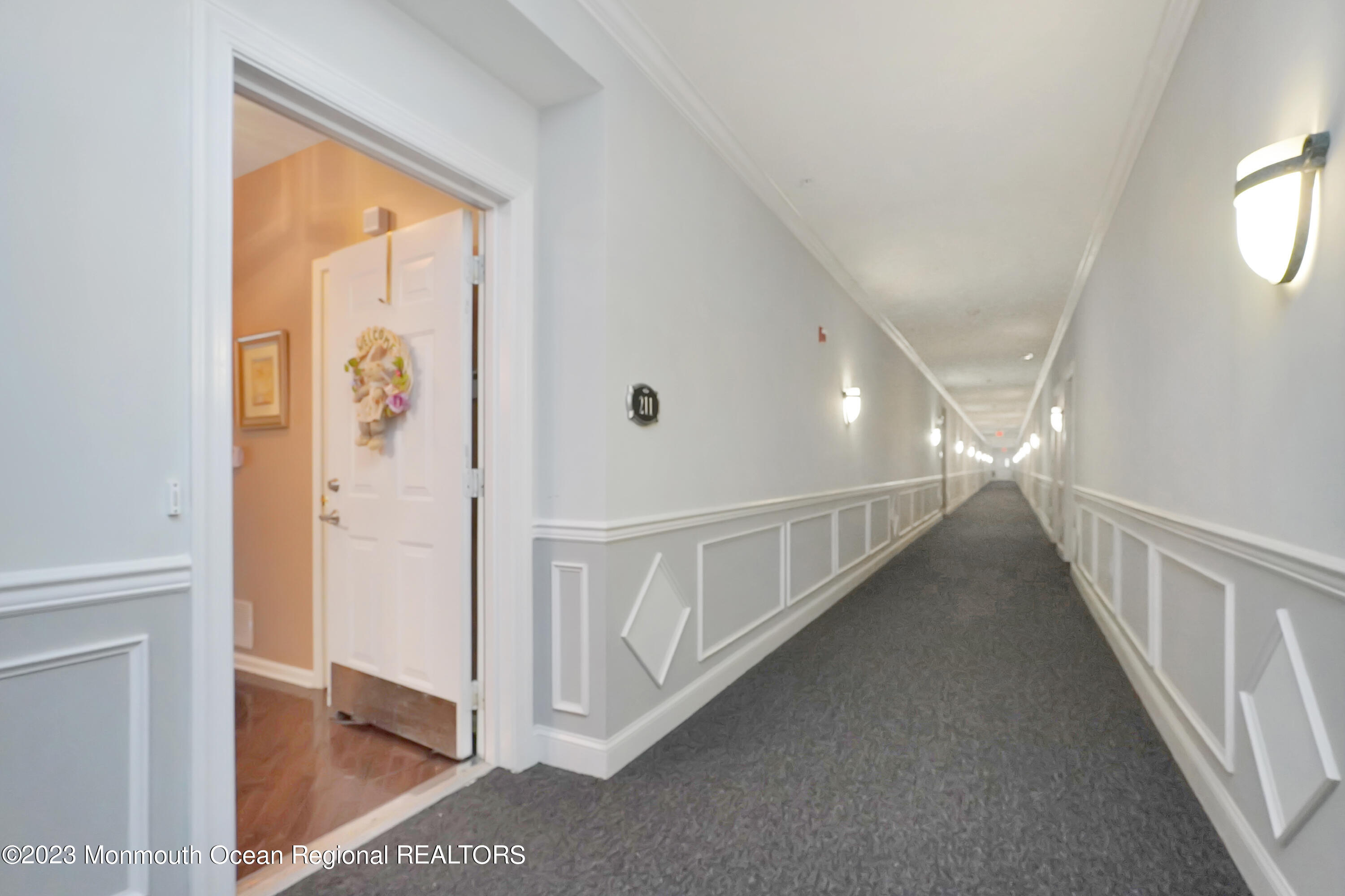 211 Potts Road Morganville, NJ 07751 - Photo 3 of 29 a view of a hallway with windows
