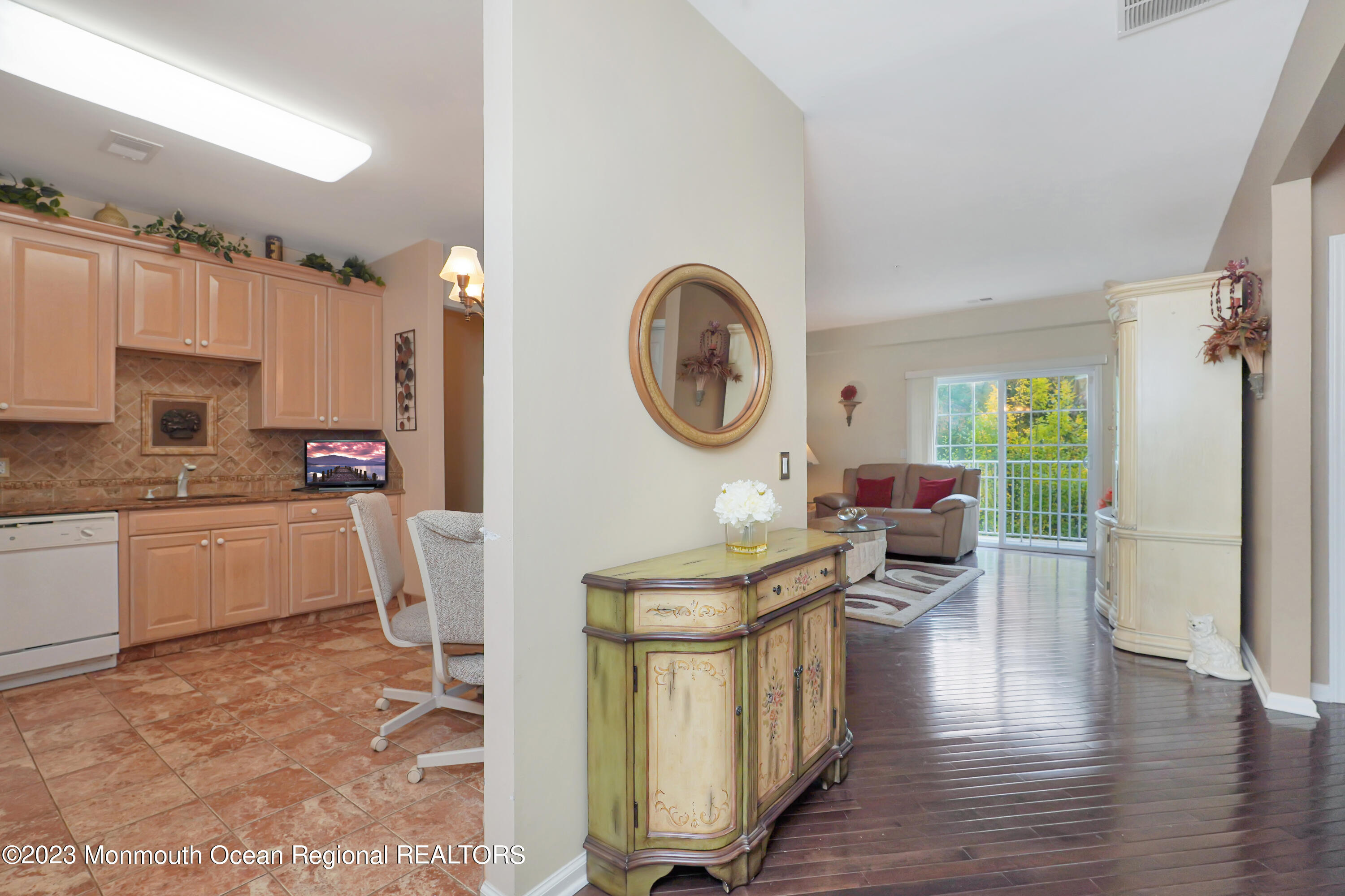 211 Potts Road Morganville, NJ 07751 - Photo 4 of 29 a kitchen with a table chairs a stove and a window