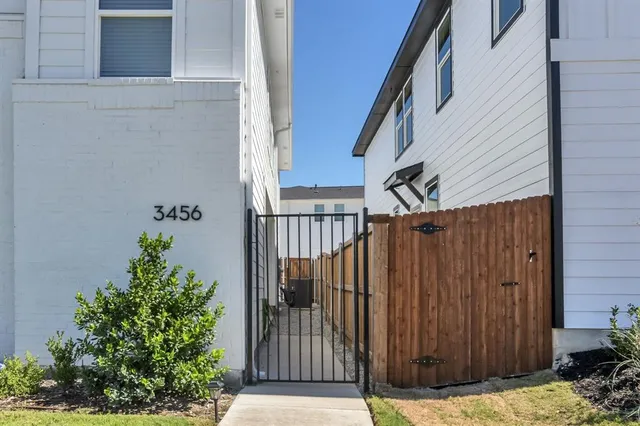 a view of a house with backyard and wooden fence