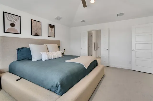 a bed room with a bed and painting