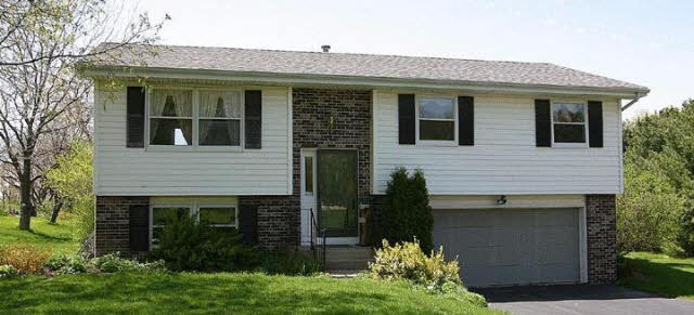 8448 Belvidere Road Caledonia, IL 61011 - Photo 1 of 4 a front view of a house with a garden