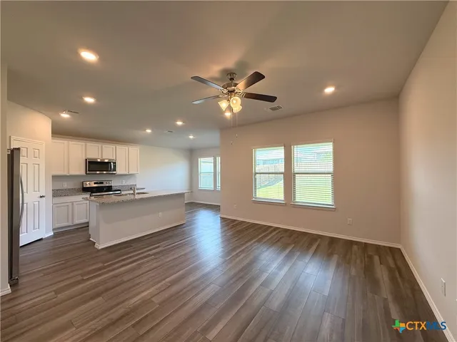 a view of kitchen with sink microwave and refrigerator