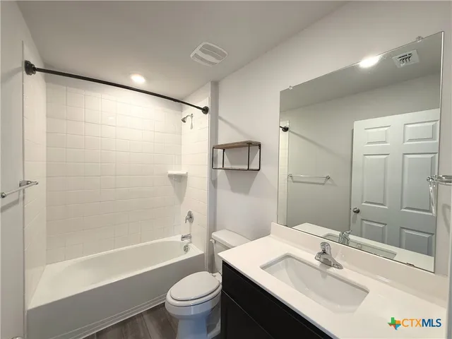 a bathroom with a sink toilet tub and shower