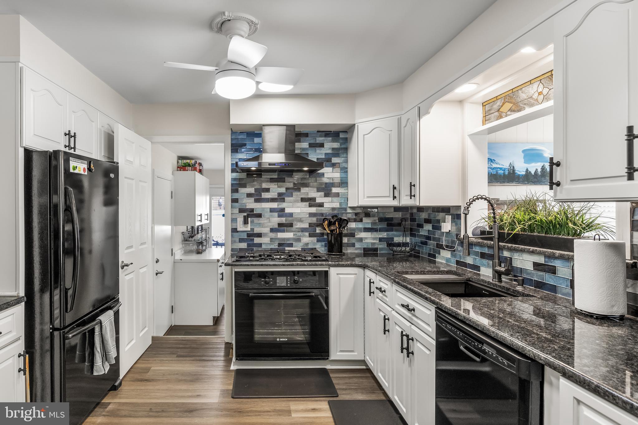 702 Heritage Road Cinnaminson, NJ 08077 - Photo 12 of 30 a kitchen with stainless steel appliances a stove sink and refrigerator