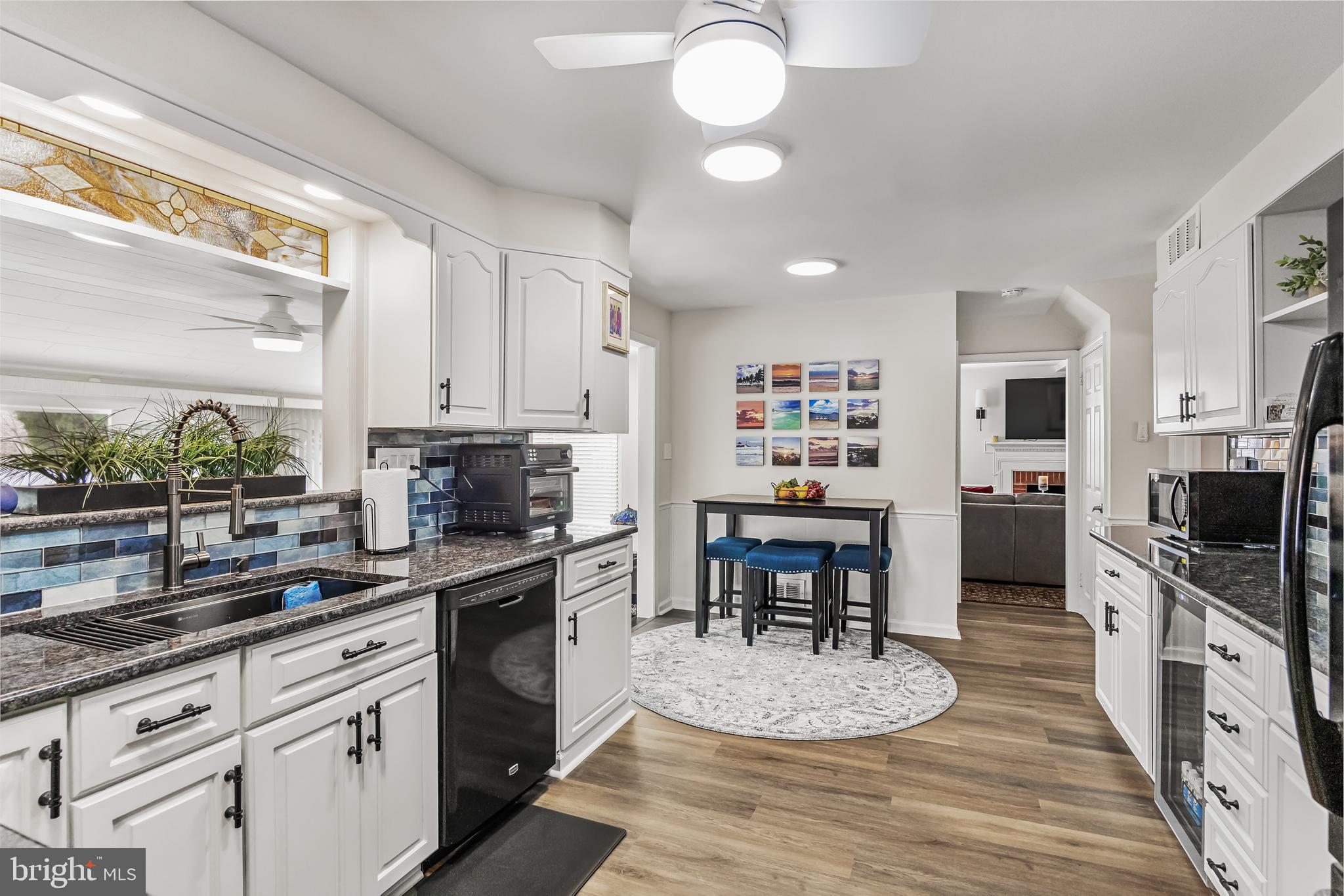 702 Heritage Road Cinnaminson, NJ 08077 - Photo 13 of 30 a kitchen with stainless steel appliances granite countertop a stove refrigerator and a sink