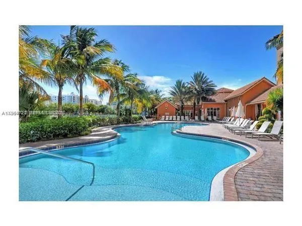a swimming pool with outdoor seating and yard