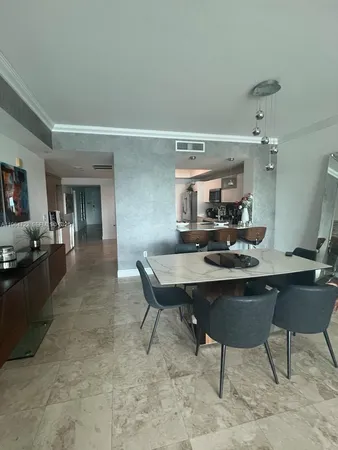 a kitchen with a sink and chairs