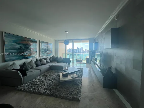 a living room with furniture and a large window