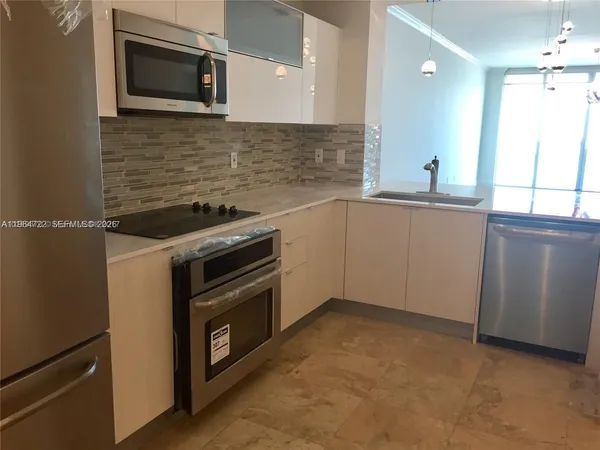 a kitchen with a stove and a microwave