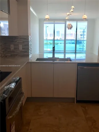 a kitchen with granite countertop a stove and a sink