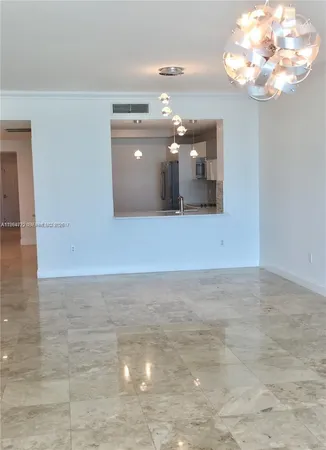 a view of a chandelier fan and fire place