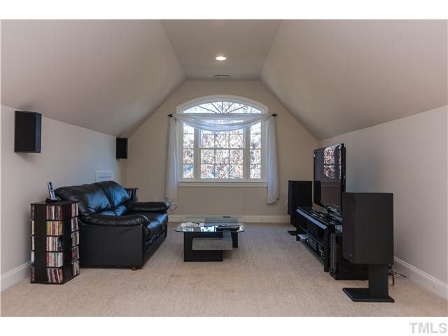 1512 Liatris Lane Raleigh, NC 27613 - Photo 21 of 25 a living room with furniture and a flat screen tv