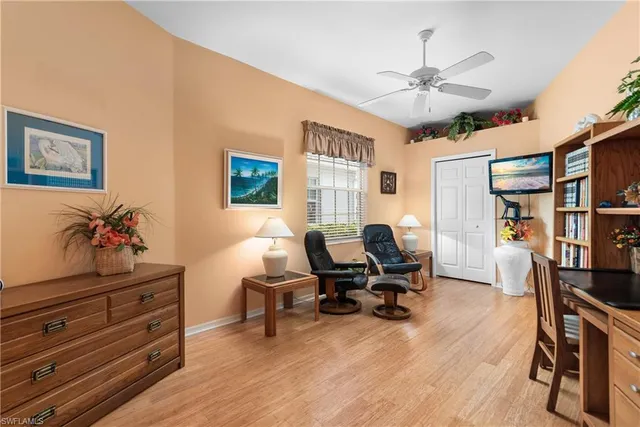 a view of a workspace with furniture and a window