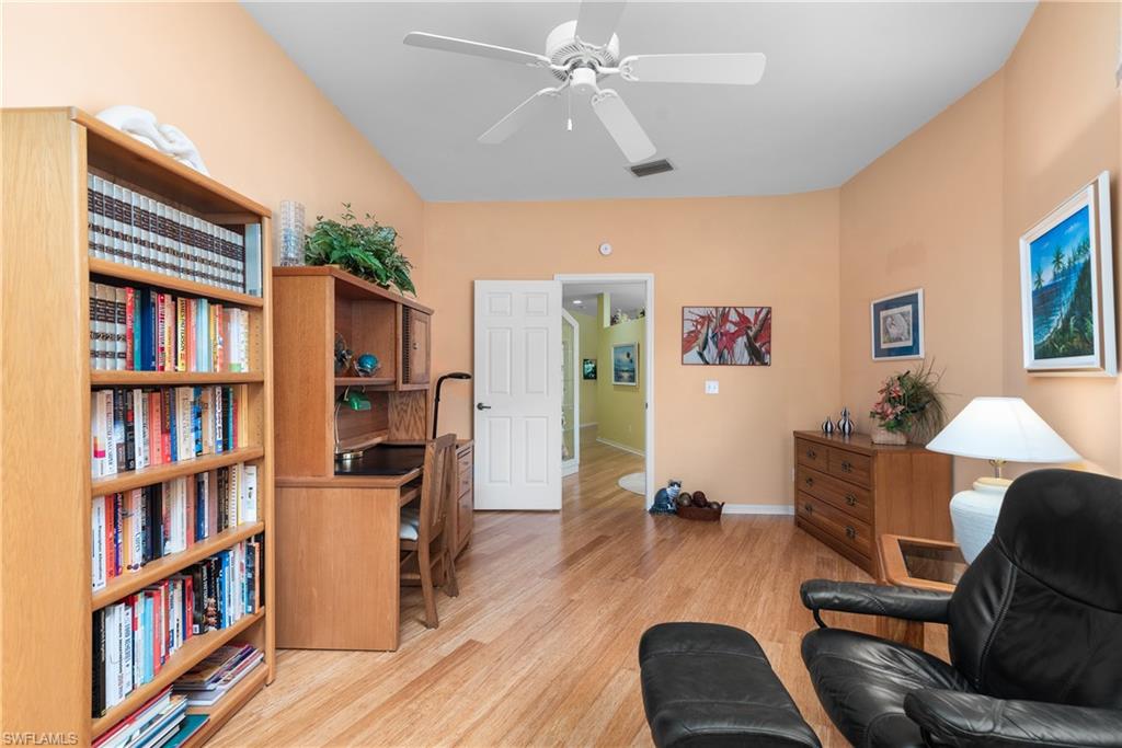455 Crossfield Circle, Unit 71 Naples, FL 34104 - Photo 12 of 29 a living room with furniture and a book shelf