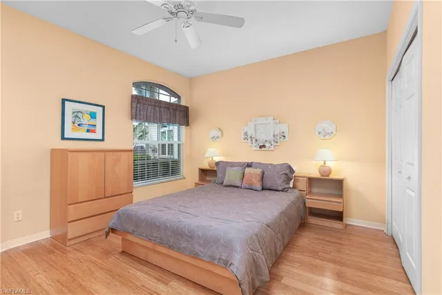 a bedroom with a large bed and a chandelier