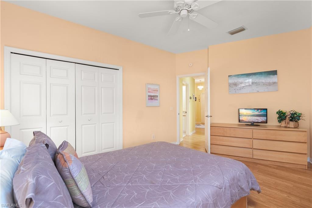 455 Crossfield Circle, Unit 71 Naples, FL 34104 - Photo 18 of 29 a bedroom with a bed and a dresser
