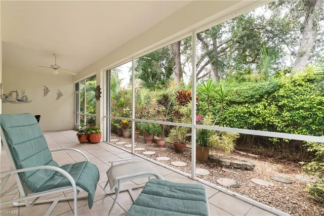a view of a patio with couches chairs and wooden floor