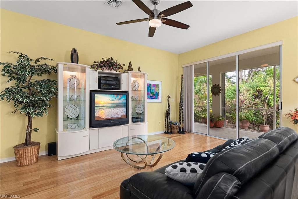 455 Crossfield Circle, Unit 71 Naples, FL 34104 - Photo 4 of 29 a living room with furniture and a flat screen tv