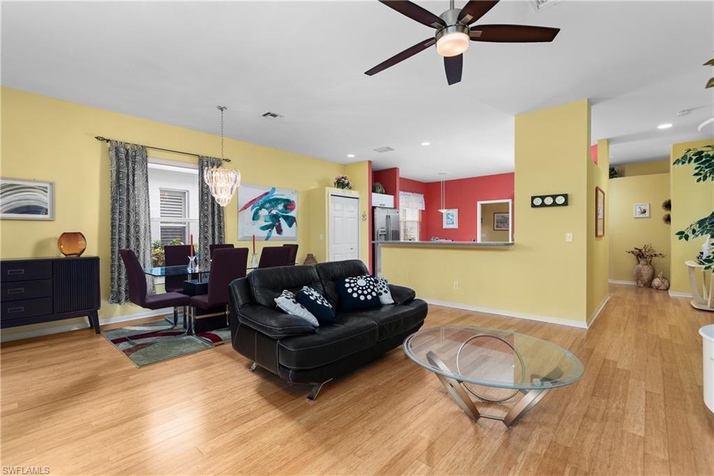 455 Crossfield Circle, Unit 71 Naples, FL 34104 - Photo 5 of 29 a living room with furniture and a wooden floor