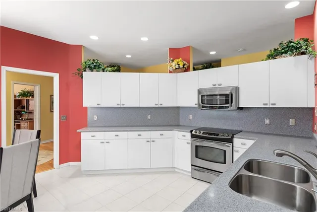 a kitchen with stainless steel appliances granite countertop a sink and cabinets