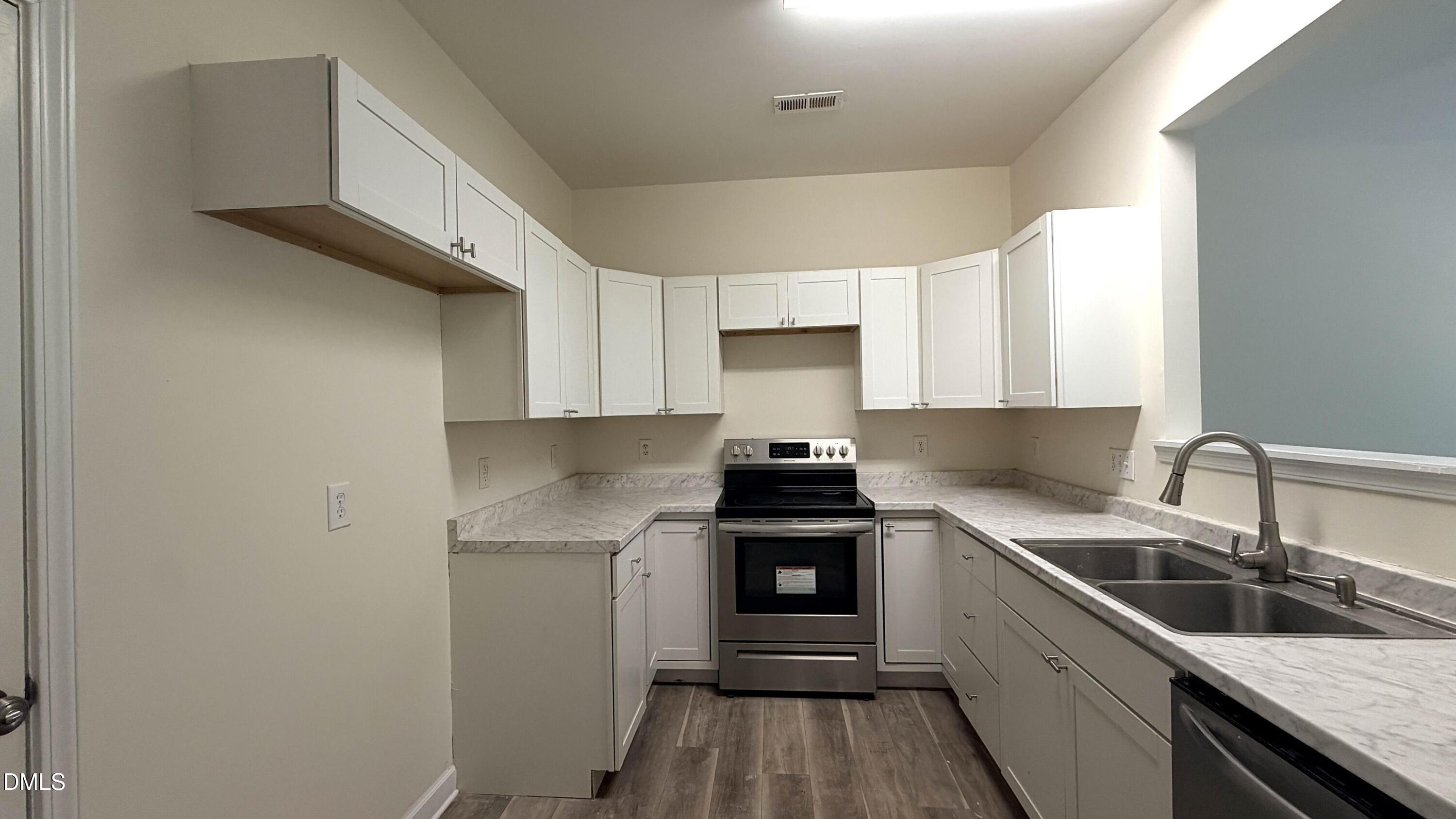 4123 Standing Rock Way Raleigh, NC 27604 - Photo 6 of 29 a kitchen with a sink cabinets and stainless steel appliances