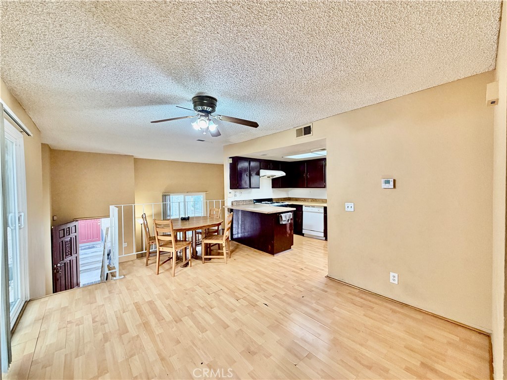 11216 Lower Azusa Road, Unit C El Monte, CA 91731 - Photo 11 of 28 a large white room with kitchen island stainless steel appliances