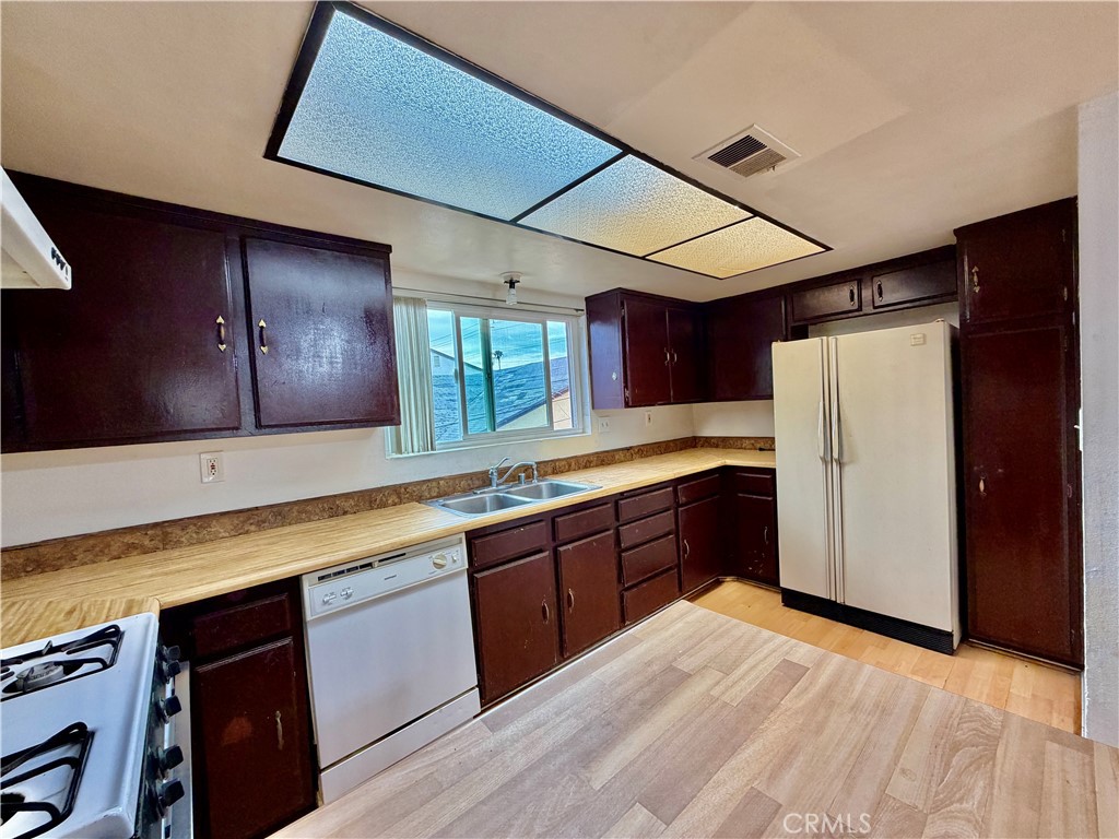 11216 Lower Azusa Road, Unit C El Monte, CA 91731 - Photo 14 of 28 a large kitchen with a large counter top space a sink stainless steel appliances and cabinets