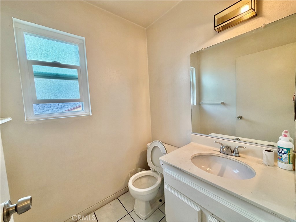 11216 Lower Azusa Road, Unit C El Monte, CA 91731 - Photo 17 of 28 a bathroom with a granite countertop sink and a mirror
