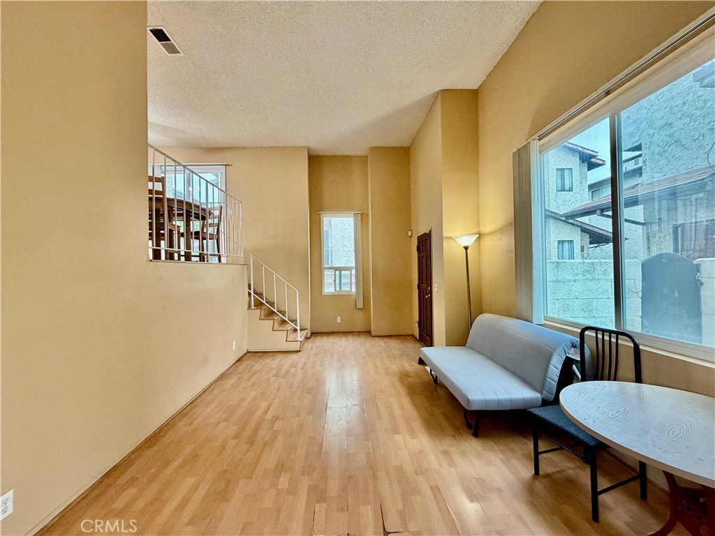 11216 Lower Azusa Road, Unit C El Monte, CA 91731 - Photo 9 of 28 a living room with furniture and a wooden floor