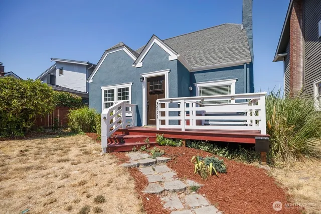 a front view of a house with a small pool and sitting area