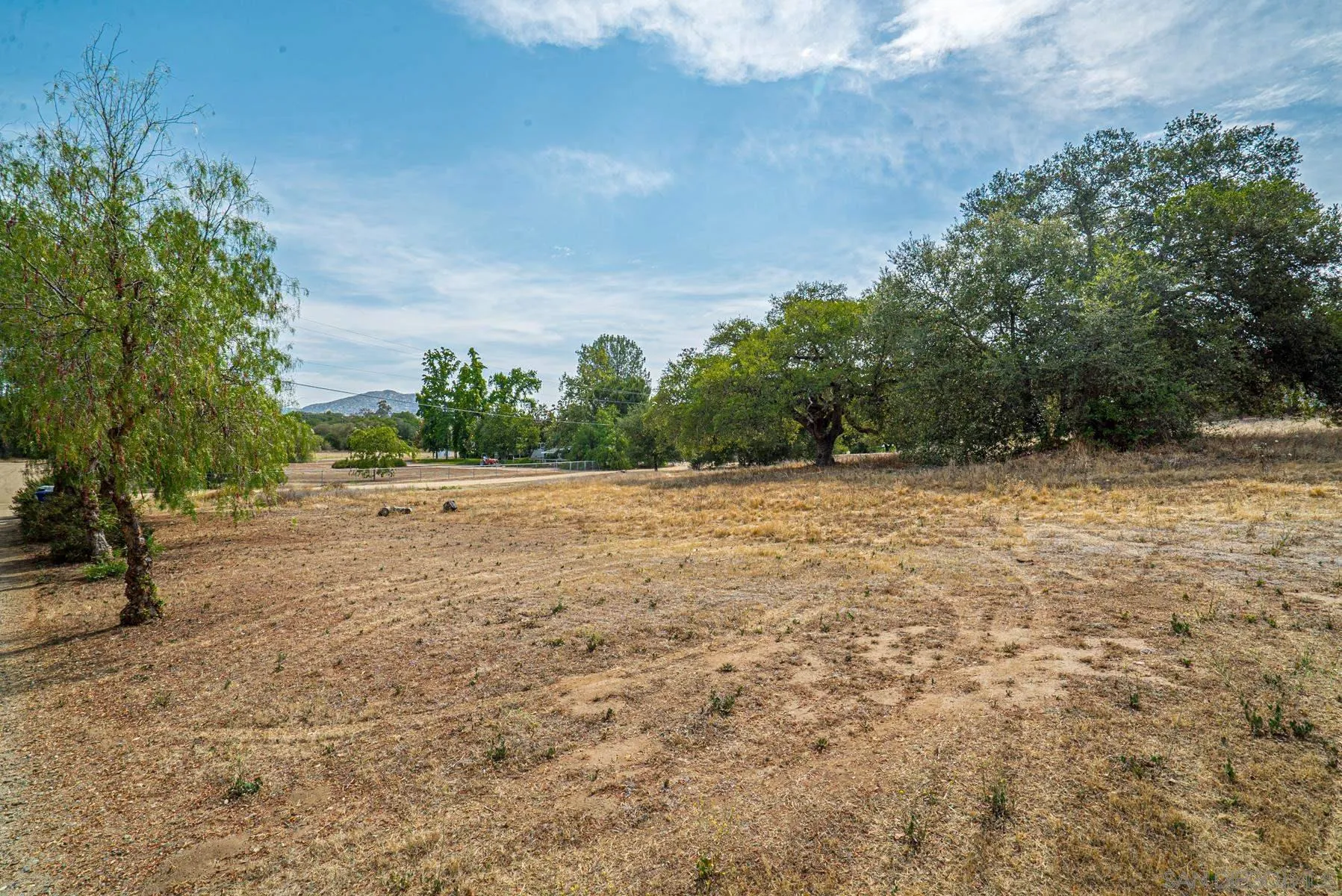 Paradise Mountain Rd Valley Center, Unit 1892302700 Valley Center, CA 92082 - Photo 2 of 24 a view of a field with trees in the background
