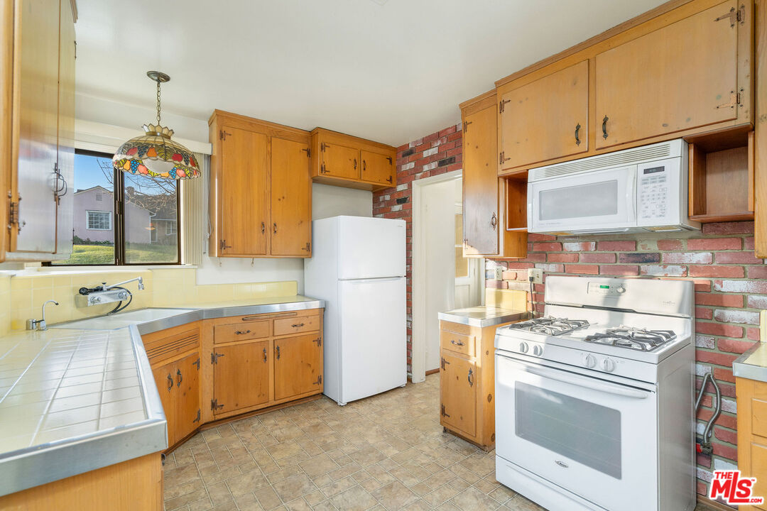 2118 Hilton Drive Burbank, CA 91504 - Photo 12 of 39 a kitchen with stainless steel appliances granite countertop a stove and a refrigerator