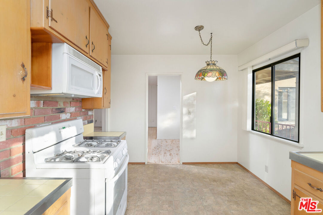 2118 Hilton Drive Burbank, CA 91504 - Photo 13 of 39 a kitchen with stainless steel appliances granite countertop a stove a sink dishwasher and a refrigerator with wooden floor