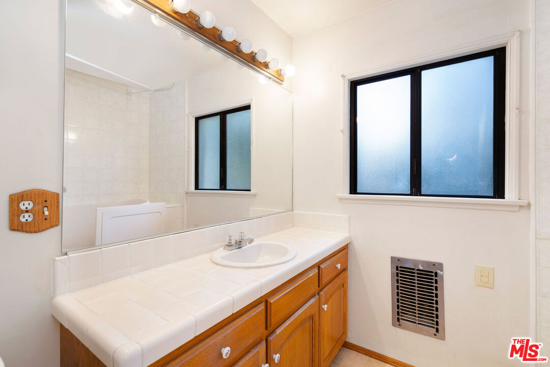 2118 Hilton Drive Burbank, CA 91504 - Photo 20 of 39 a bathroom with a sink a mirror and a shower