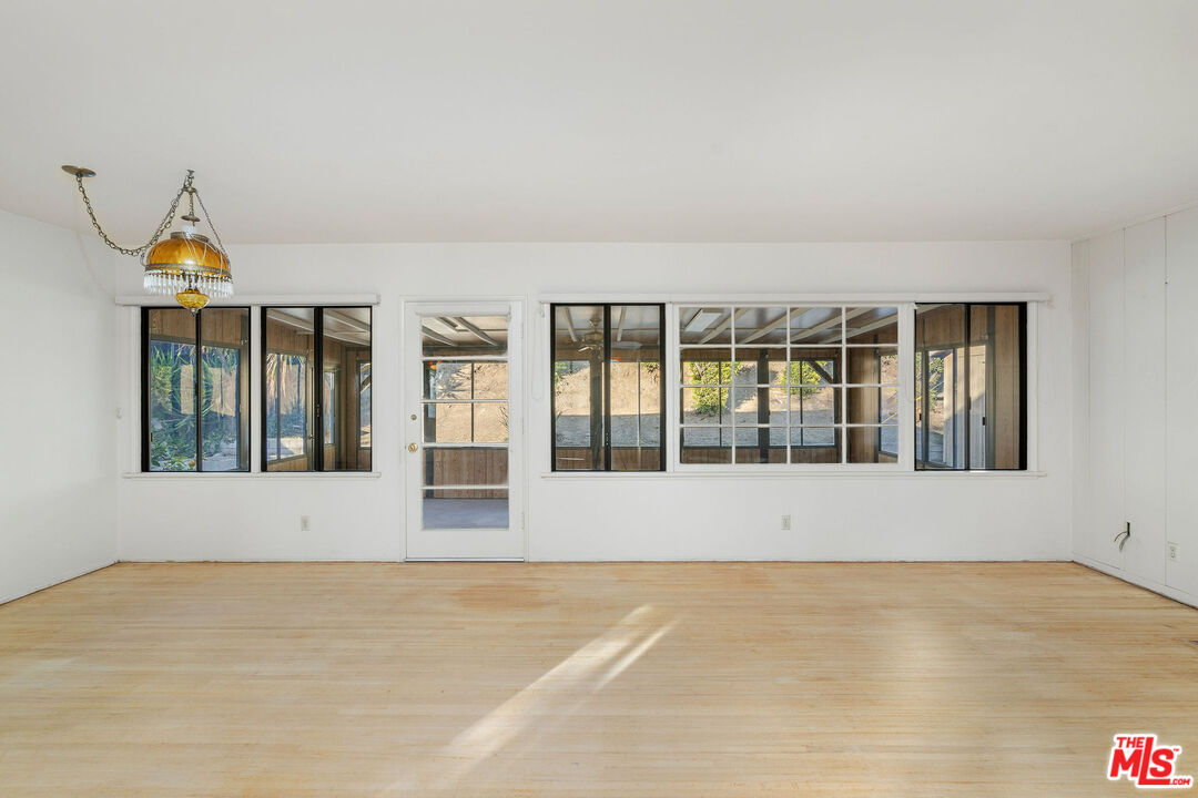 2118 Hilton Drive Burbank, CA 91504 - Photo 5 of 39 a view of an empty room with wooden floor and a window