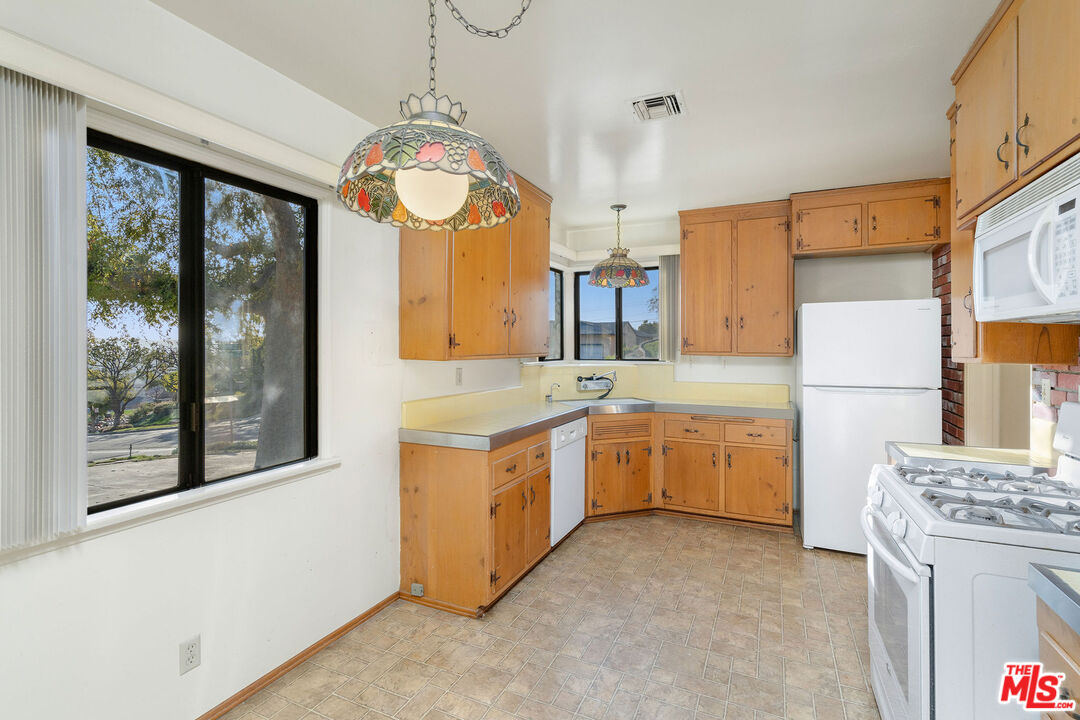 2118 Hilton Drive Burbank, CA 91504 - Photo 10 of 39 a large kitchen with a large window a sink stainless steel appliances and cabinets
