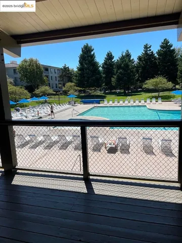 a view of a swimming pool with a yard