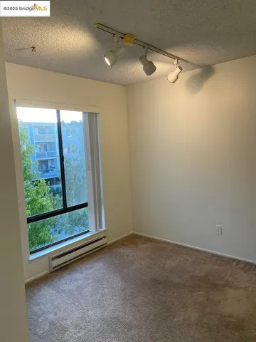 a view of a room with wooden floor and windows
