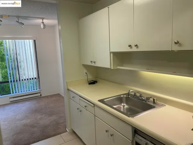 a utility room with a sink and cabinets